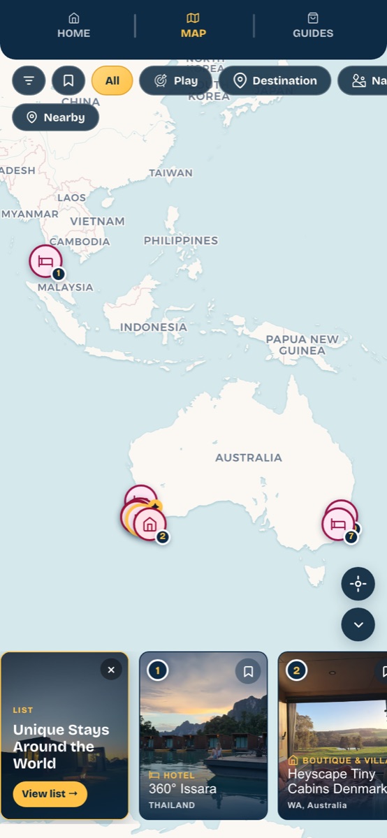 The Unique Stays list selected on the WondrOut map, with numbered pins across Australia and Thailand, on a phone